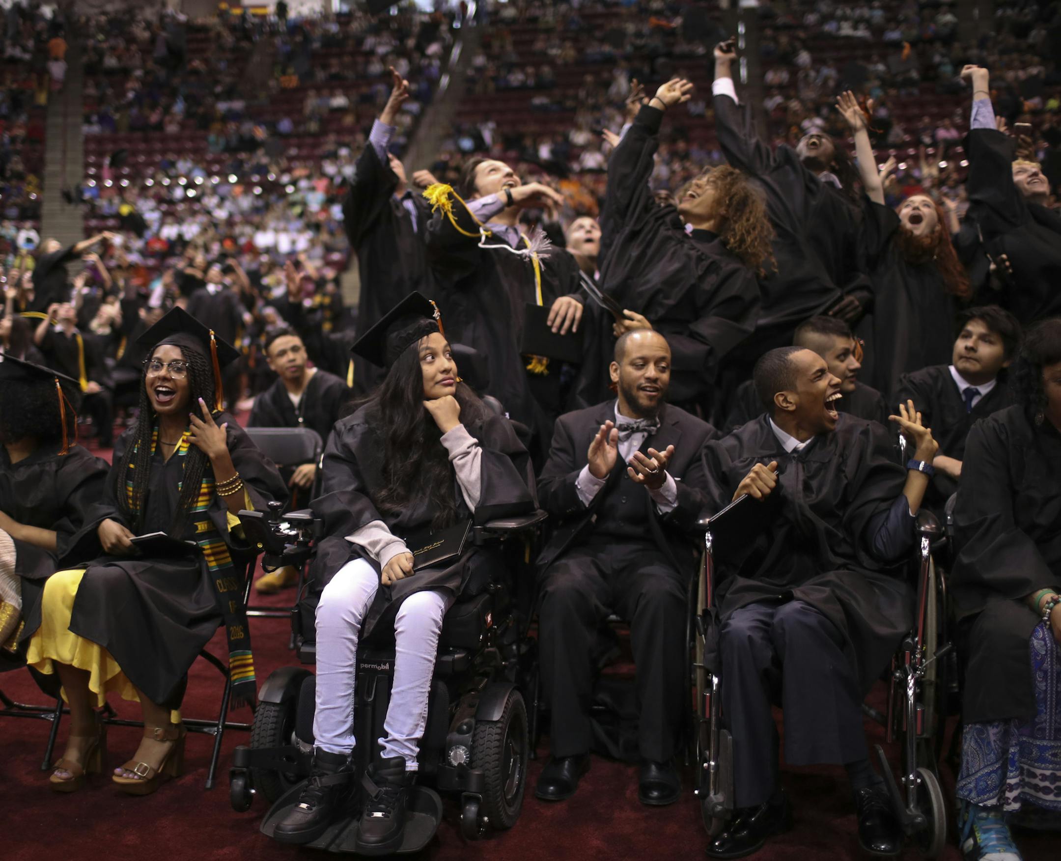 Guadalupe Galeno-Hernandez looked on as her classmates behind her tossed their mortarboards into the air at the end of the graduation ceremony Tuesday night. ] JEFF WHEELER ï jeff.wheeler@startribune.com Guadalupe Galeno-Hernandez,18, the girl who survived being shot in the throat in November 2010 by a wannabe gangster, graduated from South High School with her class Tuesday night, May 31, 2016 at Mariucci Arena on the University of Minnesota Minneapolis campus.