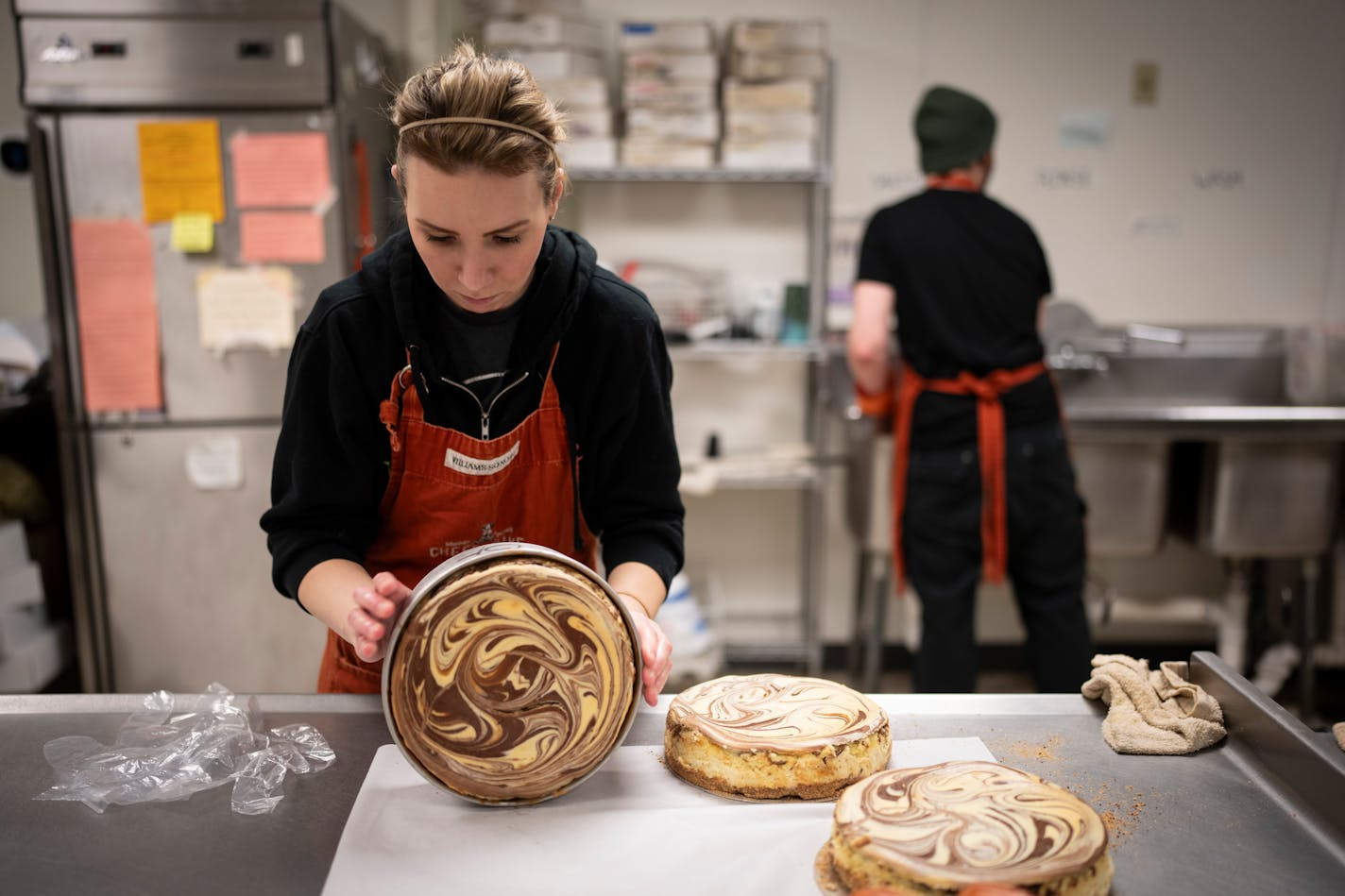 Leah Rodriguez removed gluten-free marble chocolate cheesecakes from pans to package them for pick-up Dec. 26 at Muddy Paws Cheesecake in St. Louis Park.