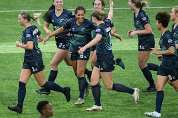 Minnesota's Shelby Hopeau (15) celebrates with teammates after scoring a goal against Green Bay during the second half.