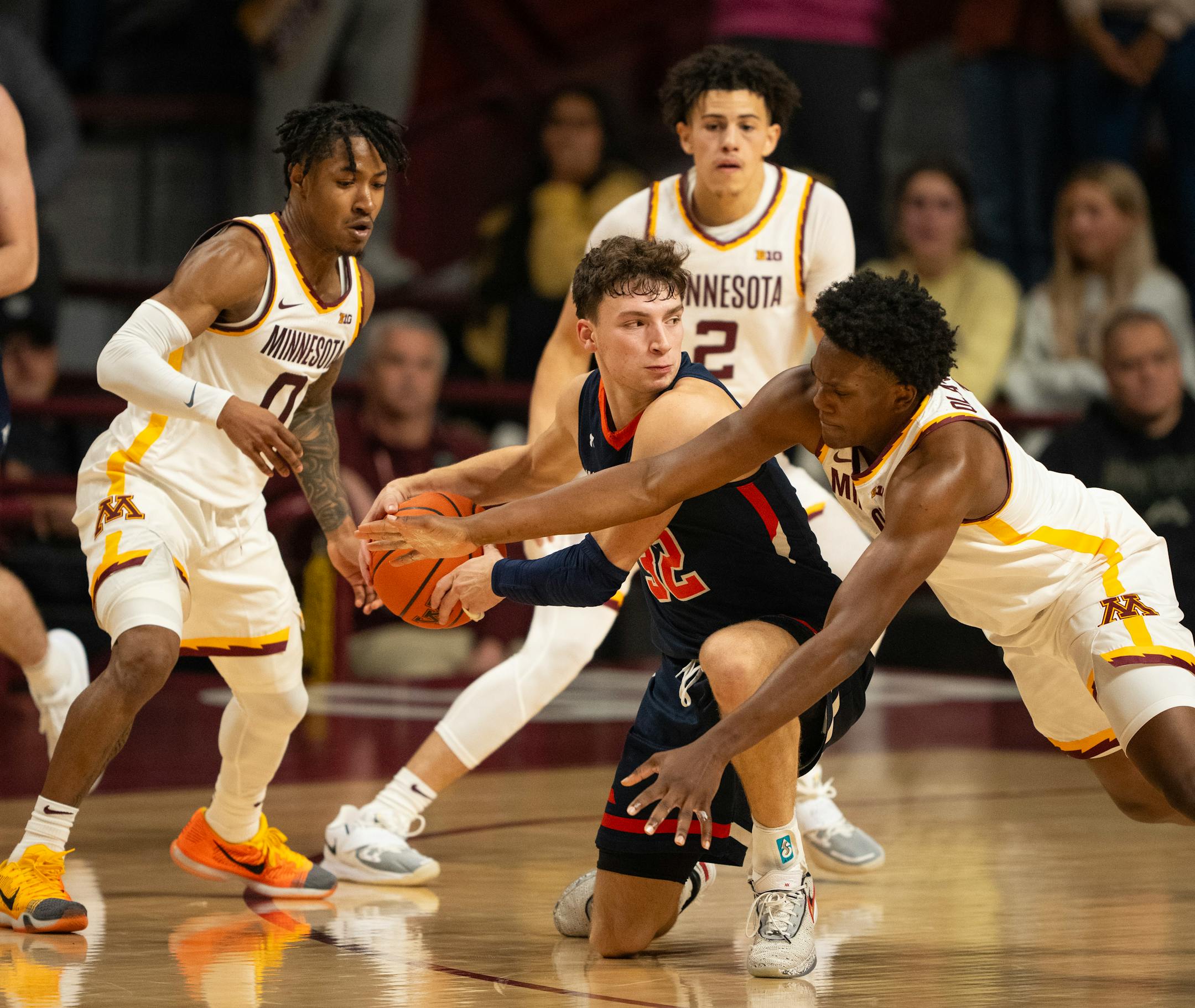 Macalester Scots guard Caleb Williams (32) eluded three Gophers with a behind-the-back pass after losing control of the ball in the second half.