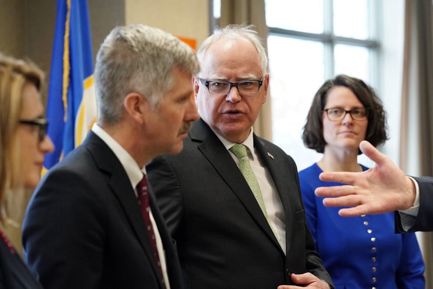 Gov. Tim Walz looked to Department of Human Services Commissioner Tony Lourey to answer a question during a press conference about the Health Care Access Fund and the provider tax Thursday.