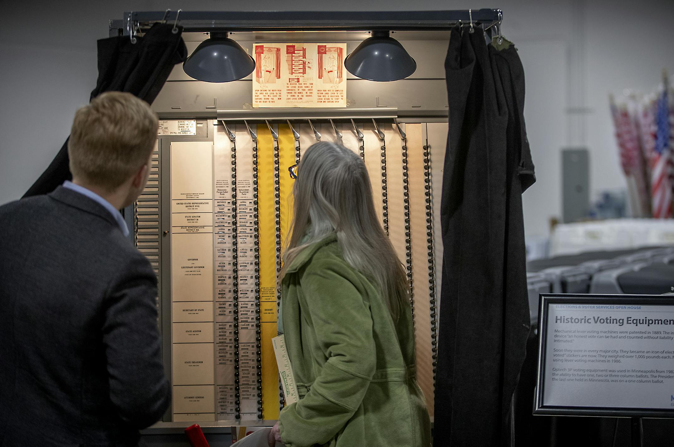 Visitors looked through a historical voting machine as they attended a ribbon cutting ceremony to open the new Elections & Voter Services, Friday, October 4, 2019 in Minneapolis, MN. The event included a tour of the new facility, including historical voting equipment, speeches, and history about Minnesota and Minneapolis’ suffrage story with the commemorative League of Women Voters exhibit in honor of the 100th Anniversary of the 19th Amendment. ] ELIZABETH FLORES • liz.flores@star