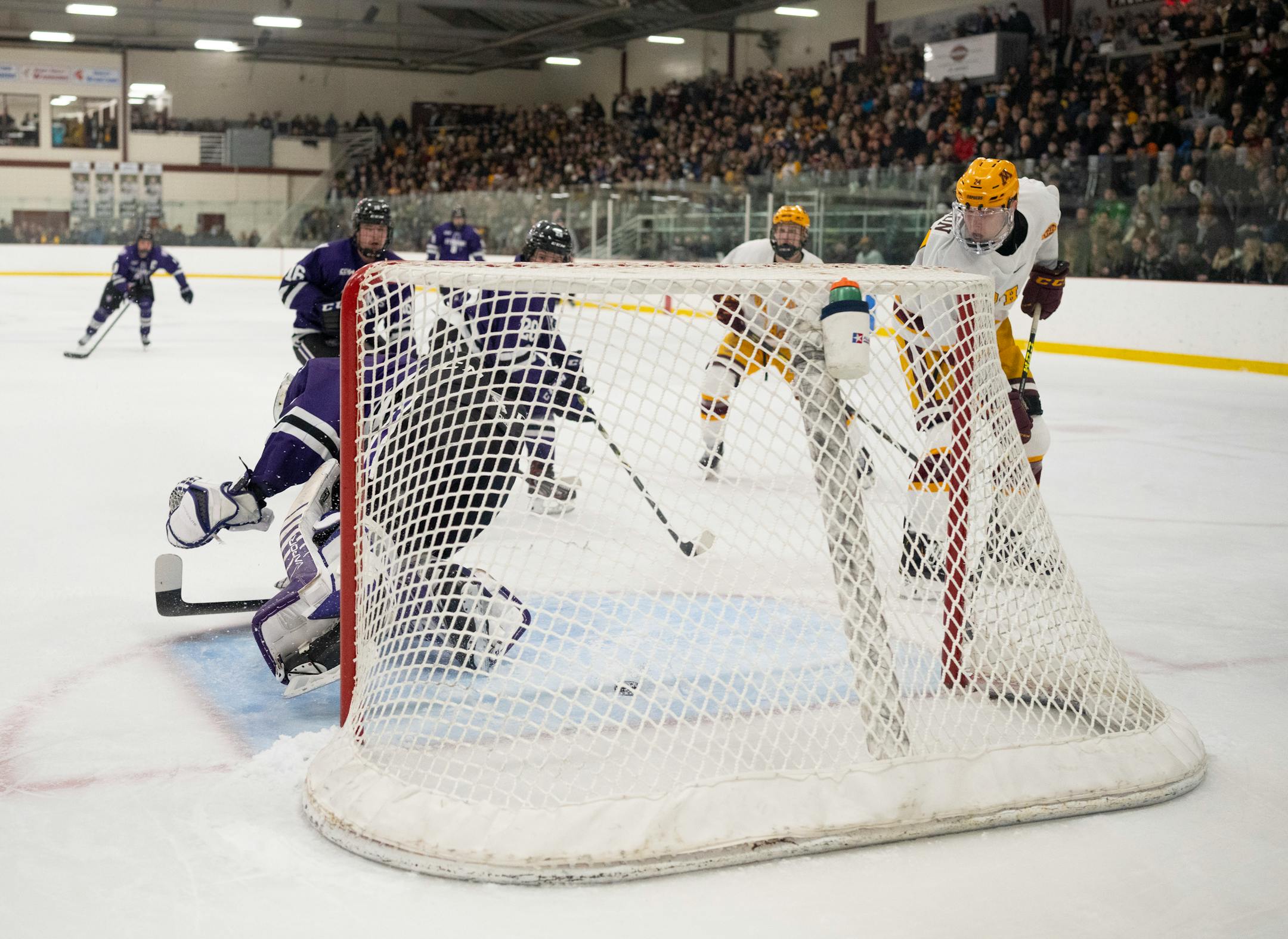 Gophers forward Jaxon Nelson (24) watched his shot slide under Tommies goaltender Peter Thome (1) for a second period goal Sunday afternoon, Jan. 2, 2022 at Doug Woog Arena in South St. Paul.