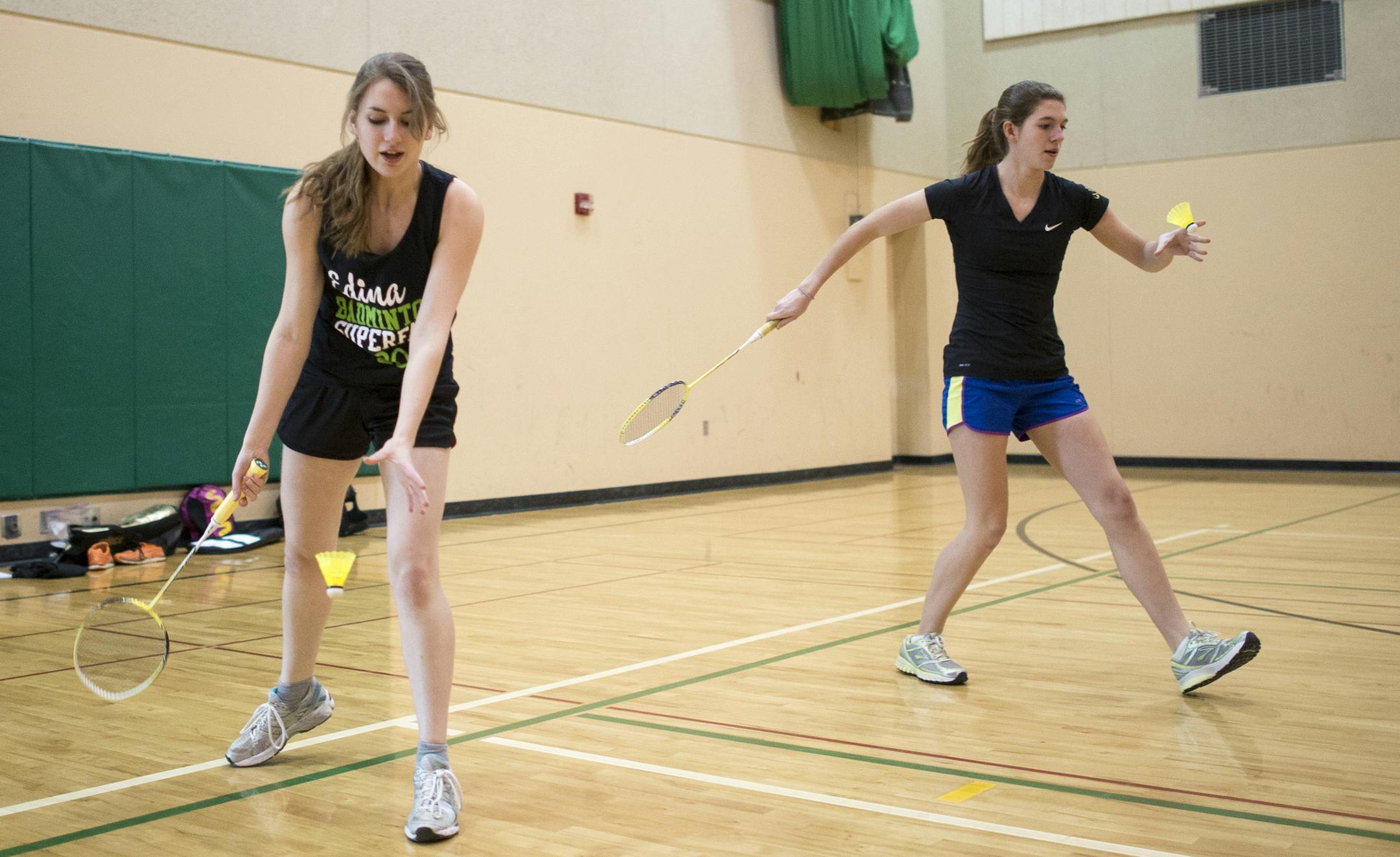 Annie Moorhead, left, a senior at Edina, and Talia Willmert, a junior, practice their serves during an Edina badminton team practice on Friday afternoon. ] (Aaron Lavinsky | StarTribune) West zone feature on growing popularity of high school badminton. An Edina practice was photographed Friday, March 28, 2015.