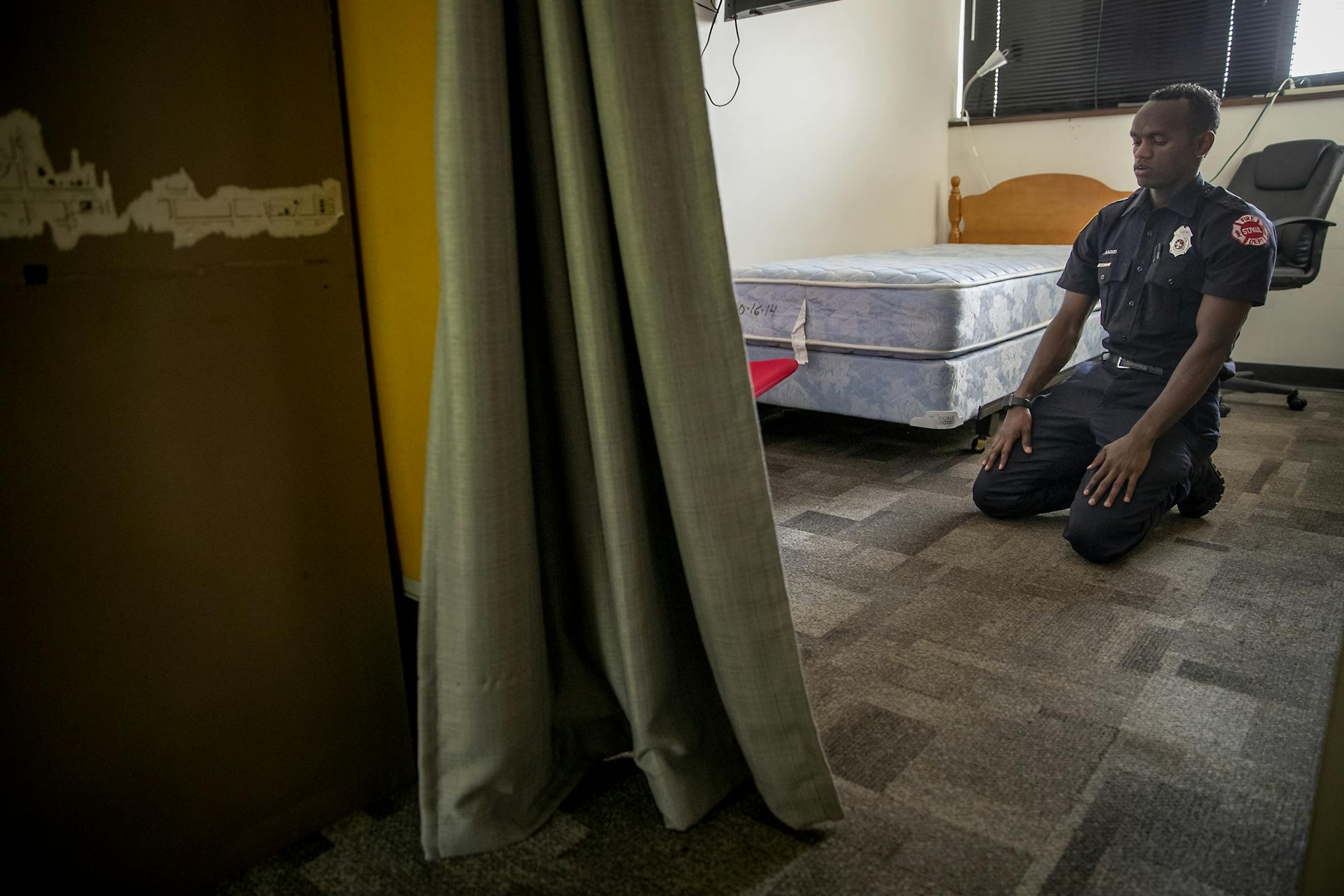 St. Paul firefighter Mohamed Daoud took a few minutes for prayer in his room during his second day on the job as one of the first Somali Americans to be sworn into the St. Paul fire department.