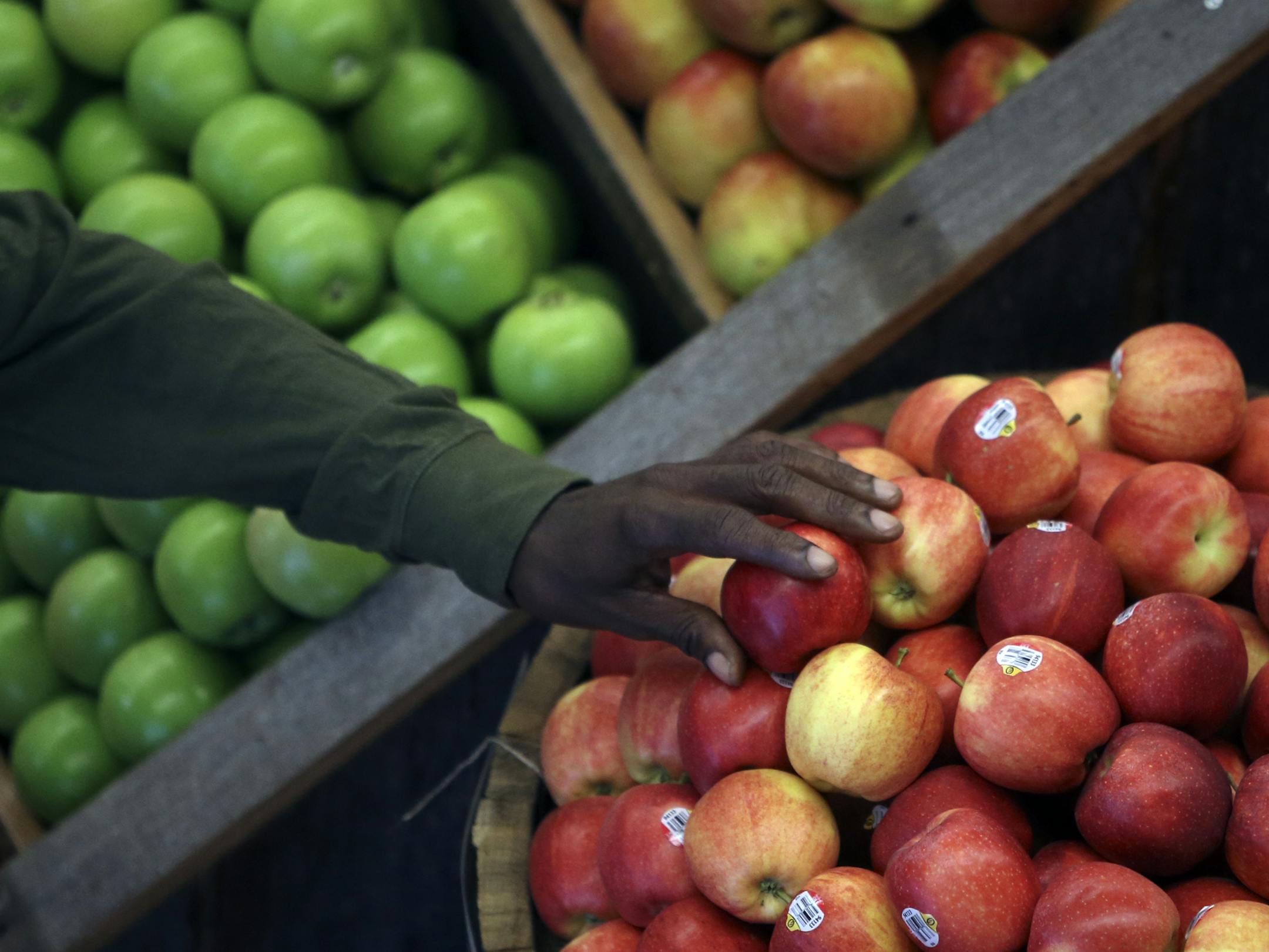 A shopper chooses an apple Wednesday, Sept. 25, 2013, during the grand opening of the Whole Foods store in downtown Minneapolis, MN.](DAVID JOLES/STARTRIBUNE) djoles@startribune.com The Whole Foods store in downtown Minneapolis isn't the city's first urban grocery store - downtown is book-ended by two Lund's stores at nearly opposite ends of Hennepin Avenue. But the arrival of the store represents a significant moment in the transformation of the once-sleepy North Loop neighborhood, which has be