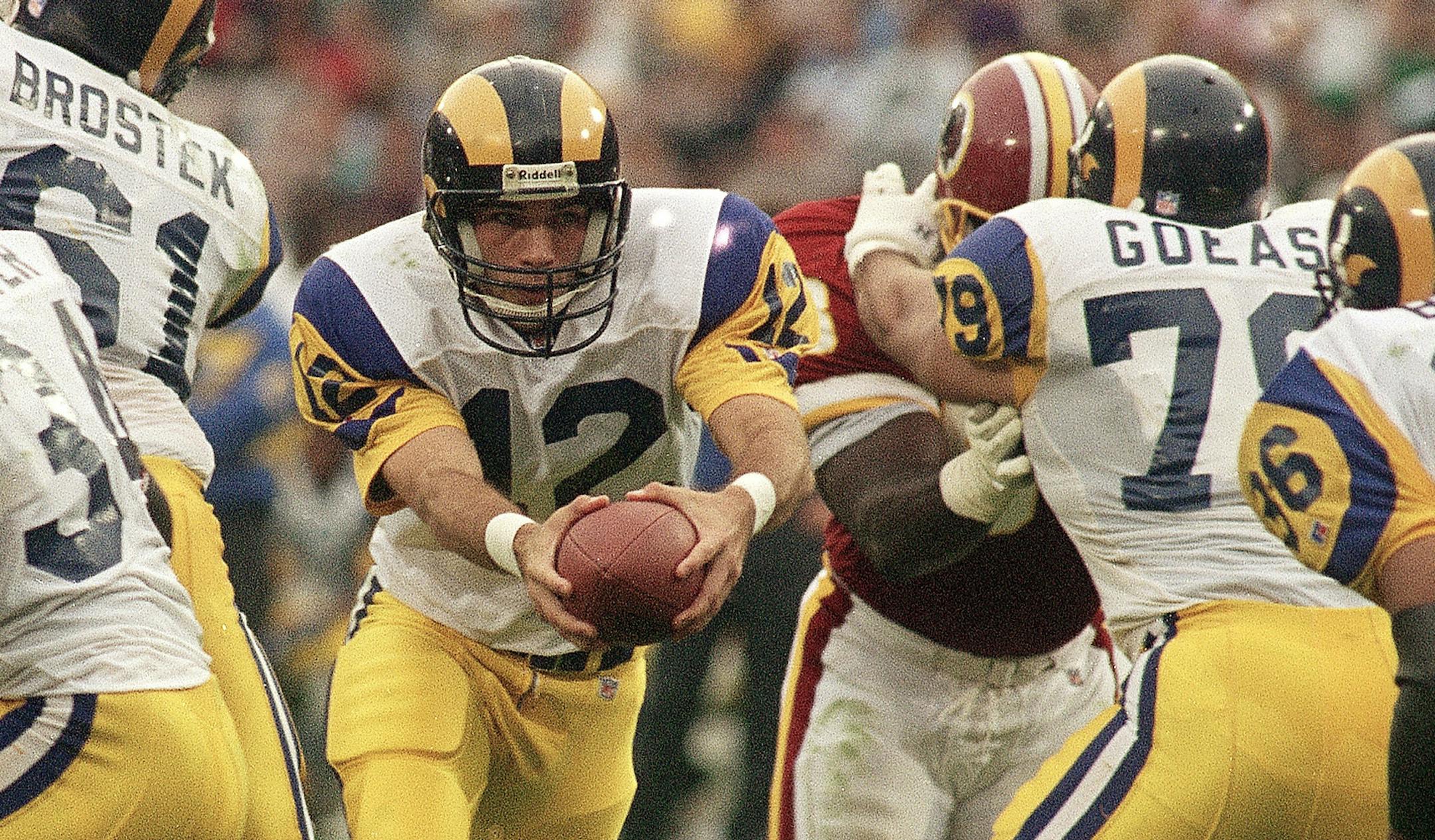 Los Angeles Rams quarterback T.J. Rubley prepares to hand off to Jerome Bettis, right, in the fourth quarter on Nov. 21, 1993 at Anaheim Stadium. Rubley replaced Jim Everett, threw a touchdown pass and directed another drive to a field goal to rally the Rams to a 10-6 victory over the Washington Redskins. (AP Photo/Chris Martinez) ORG XMIT: APHS136355