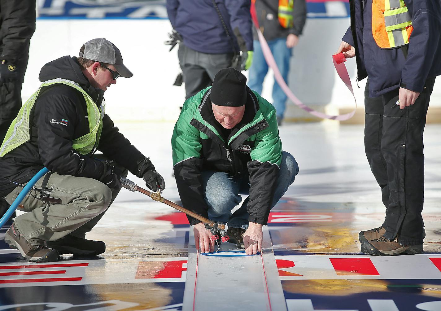 National Hockey League's Dan Craig laid the center dot in the middle of the outdoor rink that was being put together inside TCF Bank Stadium, Tuesday, February 16, 2016 in Minneapolis, MN. They were transforming TCF Bank Stadium into a world-class hockey venue for the 2016 Coors Light NHL Stadium Series that will be taking place this weekend. ] (ELIZABETH FLORES/STAR TRIBUNE) ELIZABETH FLORES &#x2022; eflores@startribune.com