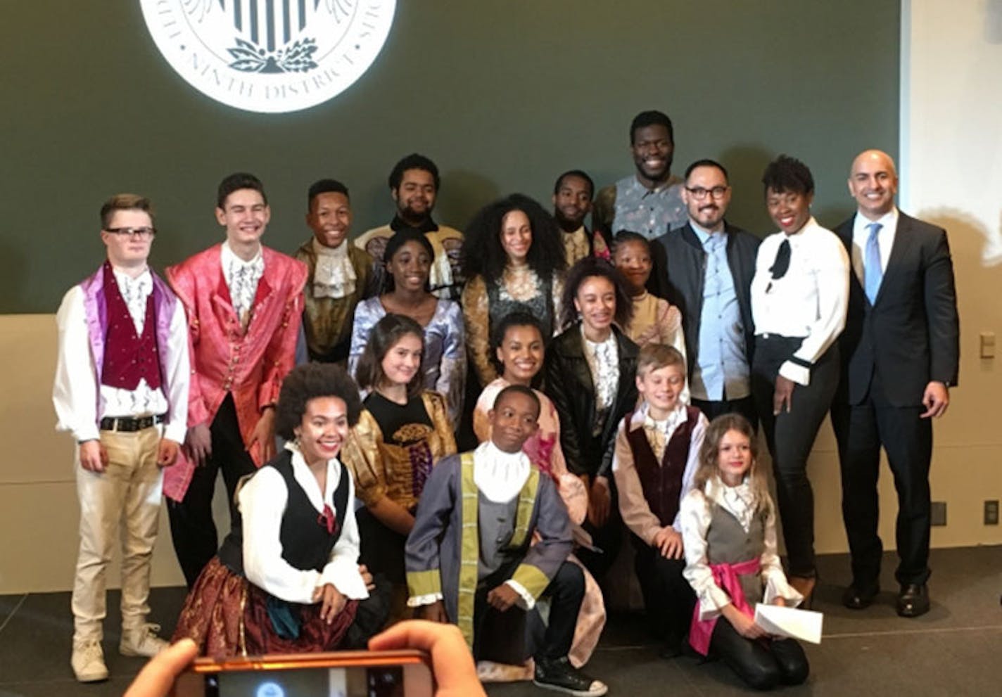 Students from the Lundstrum Center pose for a post-performance photo with three 'Hamilton' actors and the president of the Federal Reserve Bank of Minneapolis.