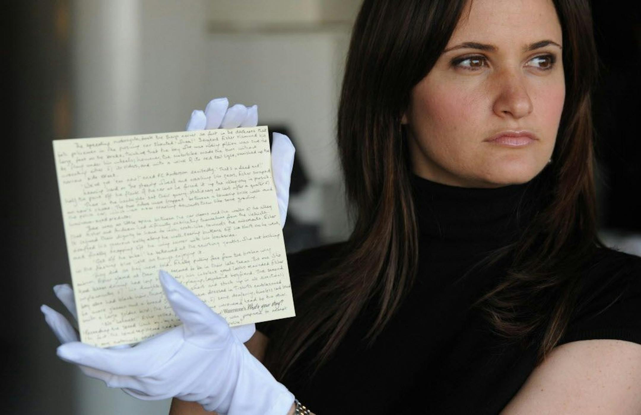 FILE - In this June 10, 2008 file photo, a member of staff at Waterstones holds a story written by JK Rowling donated by the author, for the What's Your Story? auction in aid of English PEN and Dyslexia Action, in London. West Midlands Police said Friday May 12, 2017, that the handwritten Harry Potter prequel has been stolen along with some jewelry, during a burglary in Birmingham, central England between April 13 and 24.