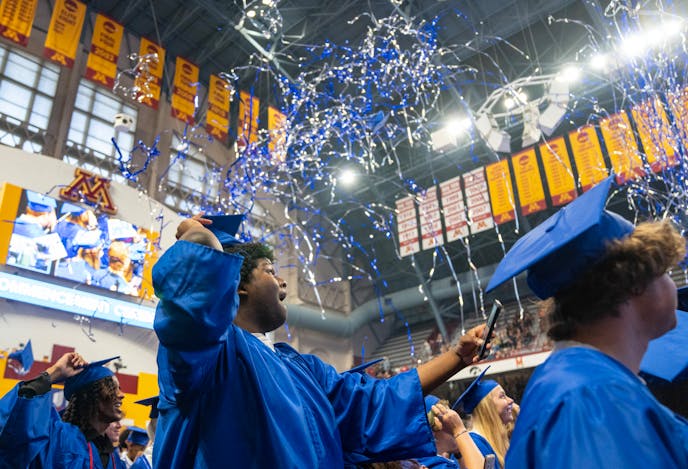 Wynton Haulcy prepare to throw his cap in the air while confetti fires at the conclusion of the Hopkins High School graduation ceremony Tuesday, June 6, 2023, at Maturi Pavilion on the University of Minnesota campus in Minneapolis.    ]