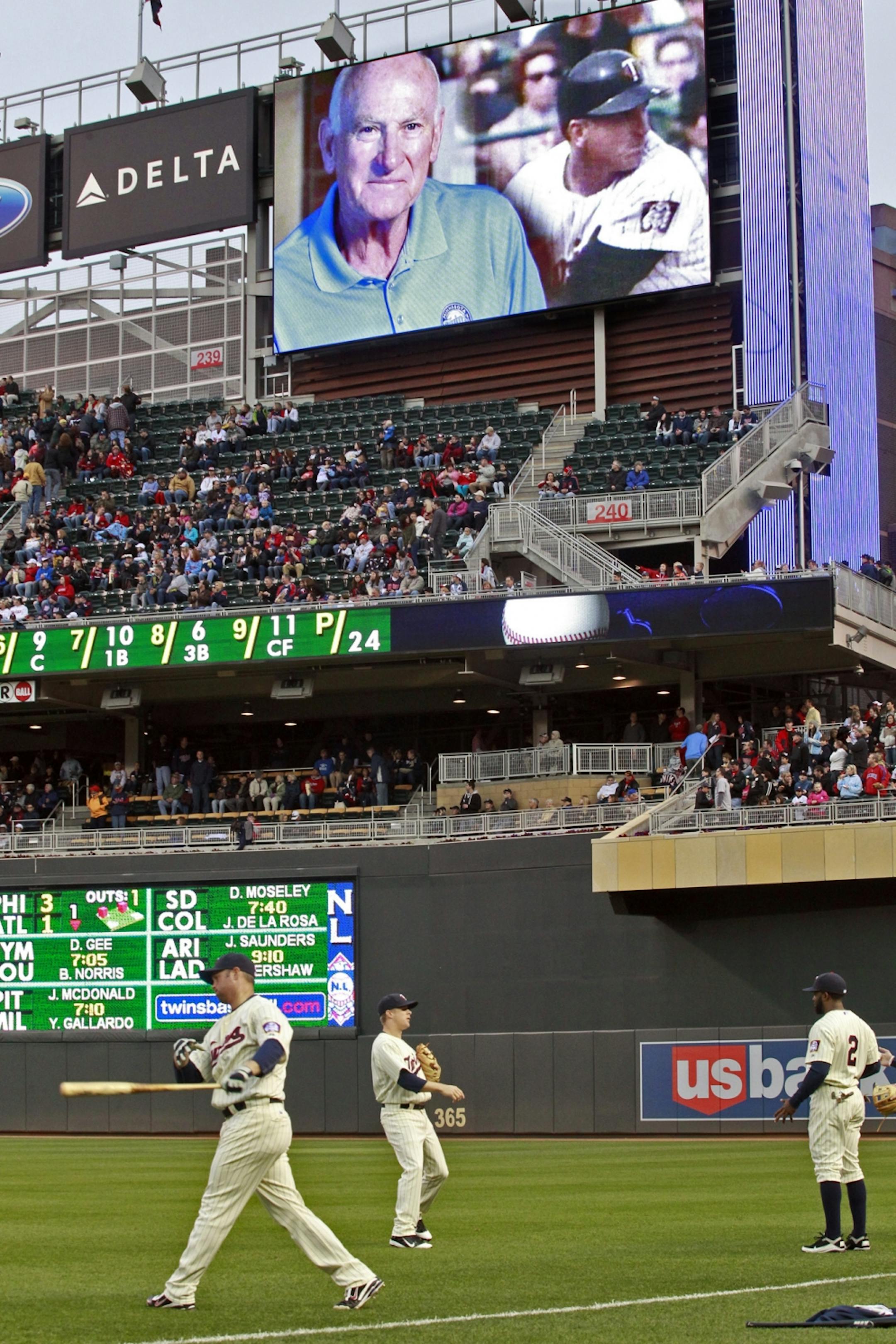 Twins players warmed up for the game as a tribute to Twins great Harmon Killebrew played on the TCF scoreboard.