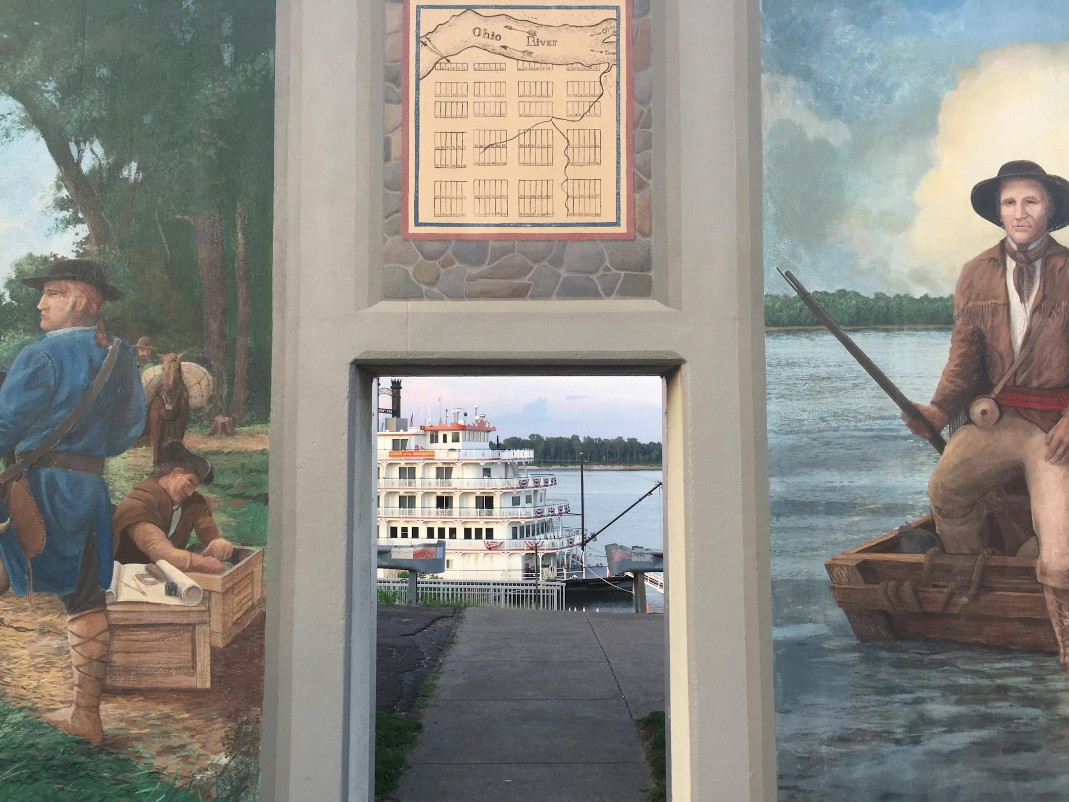 The Queen of the Mississippi steamboat paddle-wheeler can be seen through an opening in the mural-covered floodwalls in Paducah. (Lori Rackl/Chicago Tribune/TNS)