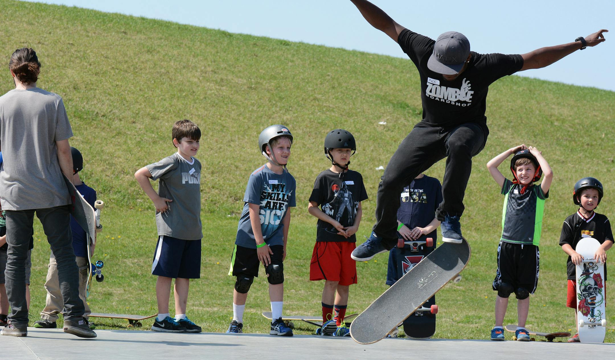 Skateboard instructor Malik Jones, of Lakeville, demonstrated a trick for kids at a beginner's skateboard clinic in Burnsville.Photo by Liz Rolfsmeier, Special to the Star Tribune