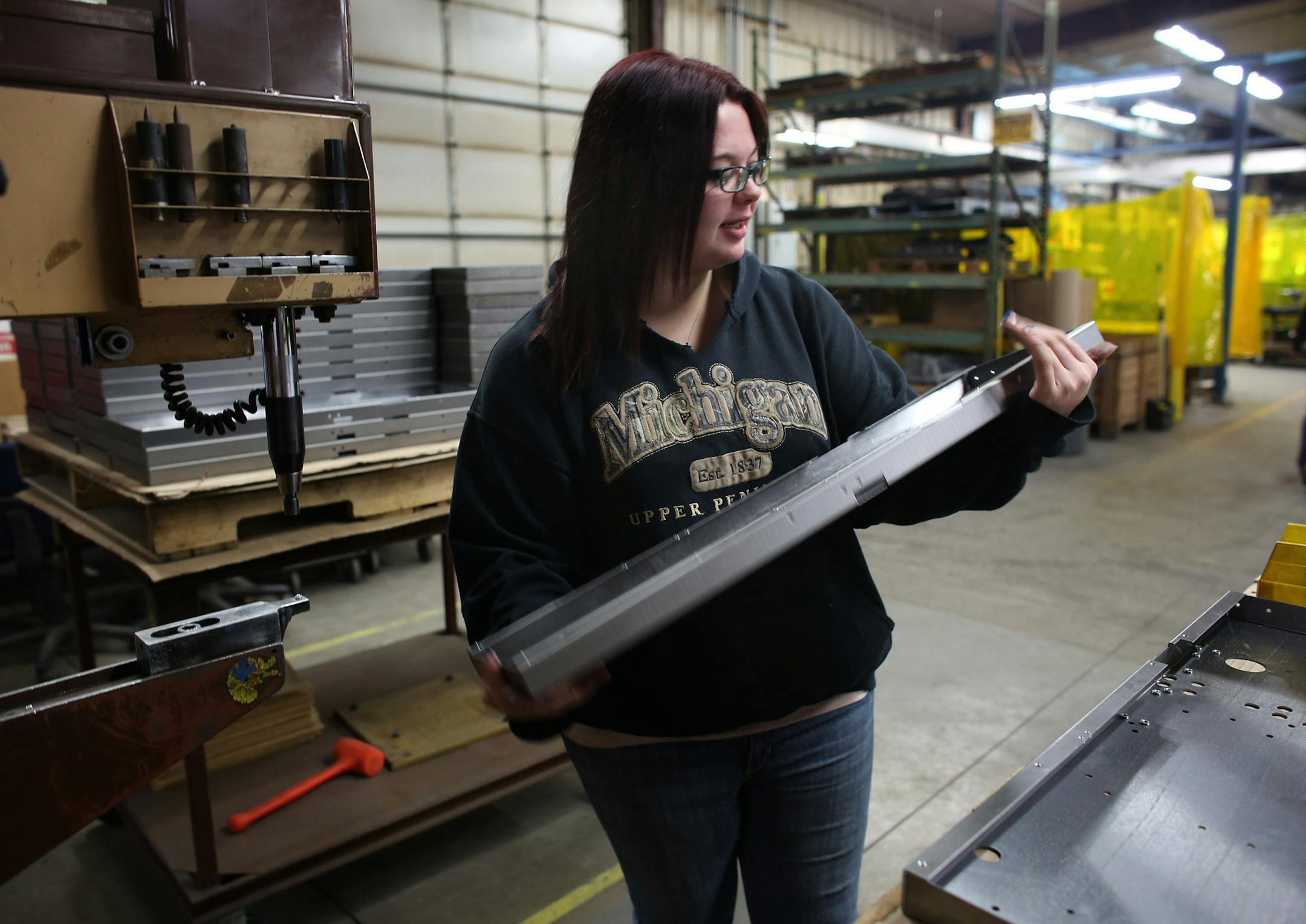 Dani Guy added metal washers on this panel as a part of her work day. ] (KYNDELL HARKNESS/STAR TRIBUNE) kyndell.harkness@startribune.com Wyoming Machine in Stacy, Min., Tuesday, December 9, 2014.