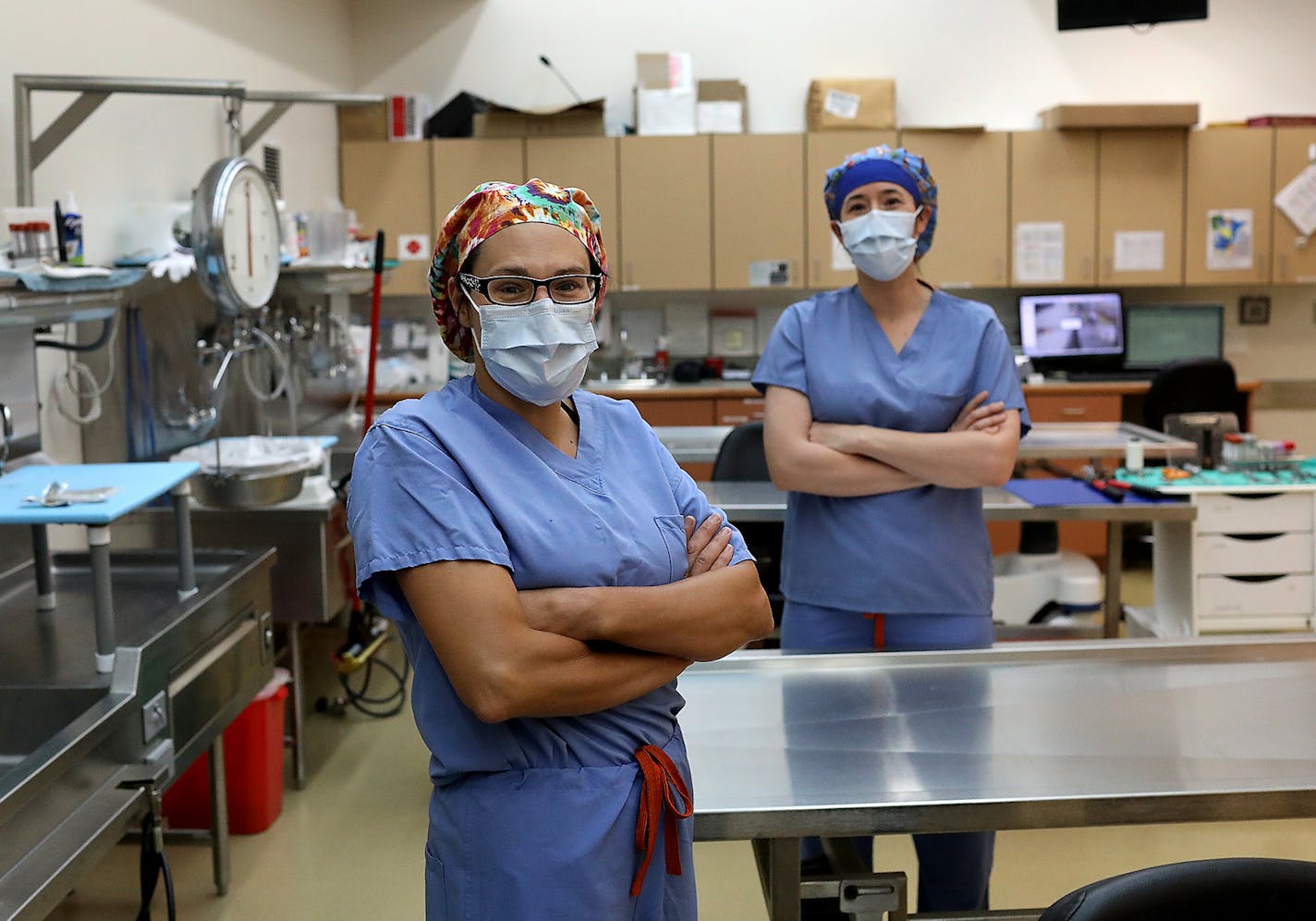 Dr. Quinn Strobl, medical examiner for Anoka County and for Midwest Medical Examiner's, left, and fellow forensic pathologist Dr. Rebecca Asch-Kendrick seen in the autopsy room Thursday, May 28, 2020, at Midwest Medical Examiner's Office in Ramsey, MN.] DAVID JOLES • david.joles@startribune.com Minnesota morgues aren't overwhelmed with bodies, and medical examiners aren't overwhelmed with autopsies. But that's not to say their lives haven't changed dramatically. Medical examiners in Minnesota ha