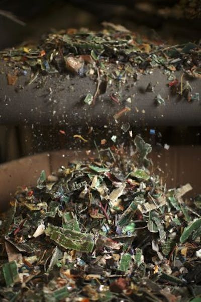 Shredded circuit boards coming off a conveyer belt at MPC in Eagan Monday afternoon.