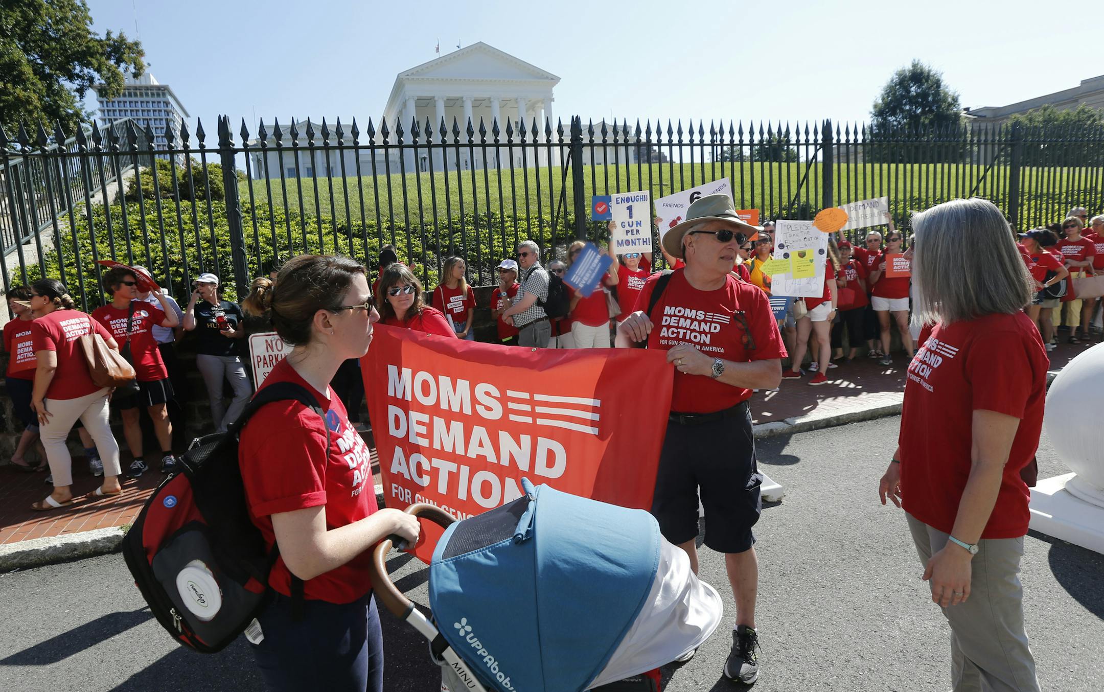 Moms Demanding Action line up during a rally at the State Capitol in Richmond, Va., Tuesday, July 9, 2019. Governor Northam called a special session of the General Assembly to consider gun legislation in light of the Virginia Beach Shootings. (AP Photo/Steve Helber)