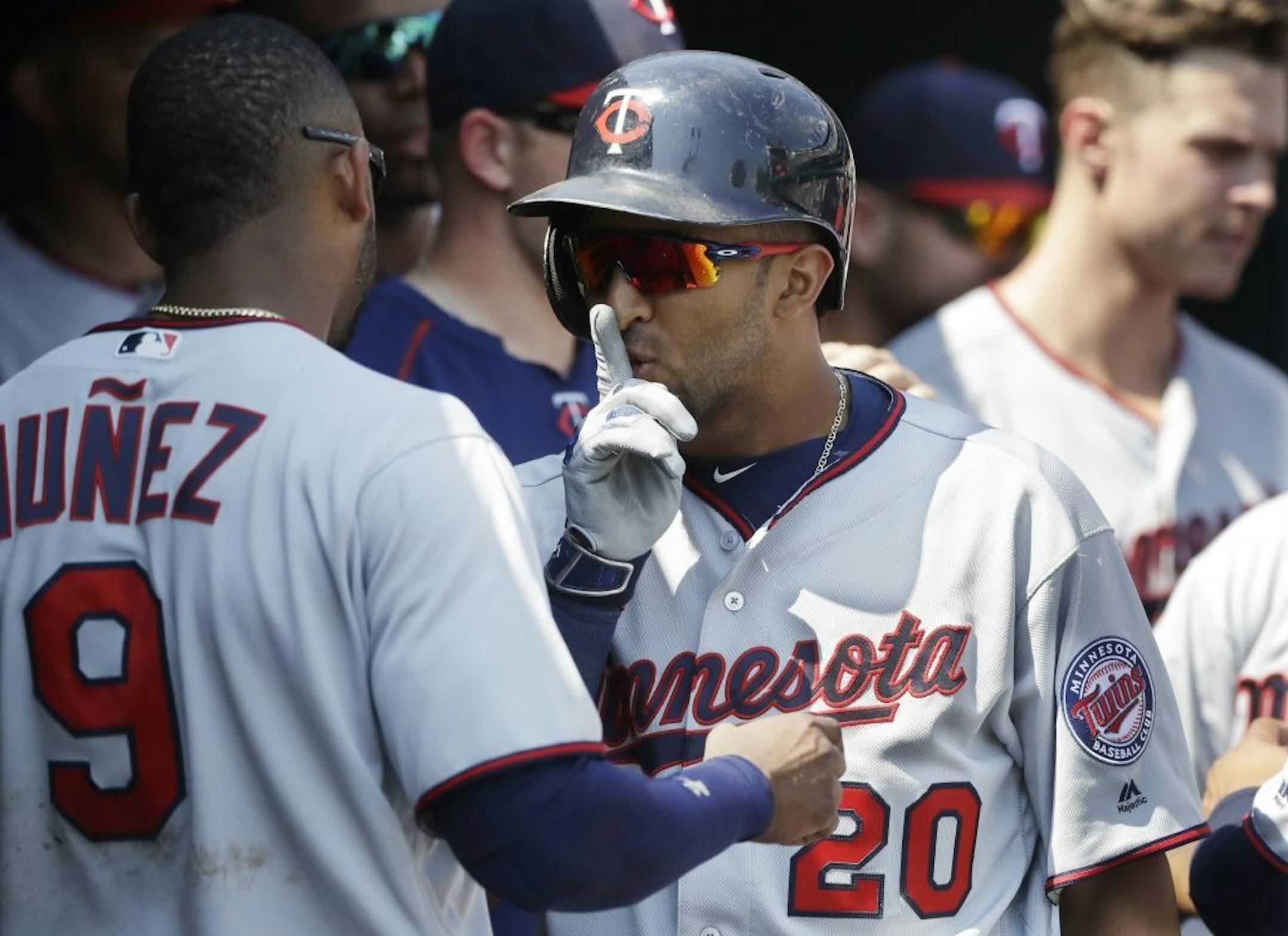 Minnesota Twins' Eddie Rosario (20) gestures to Eduardo Nunez (9) after hitting a two-run home run during the ninth inning of a baseball game against the Detroit Tigers, Wednesday, July 20, 2016 in Detroit.