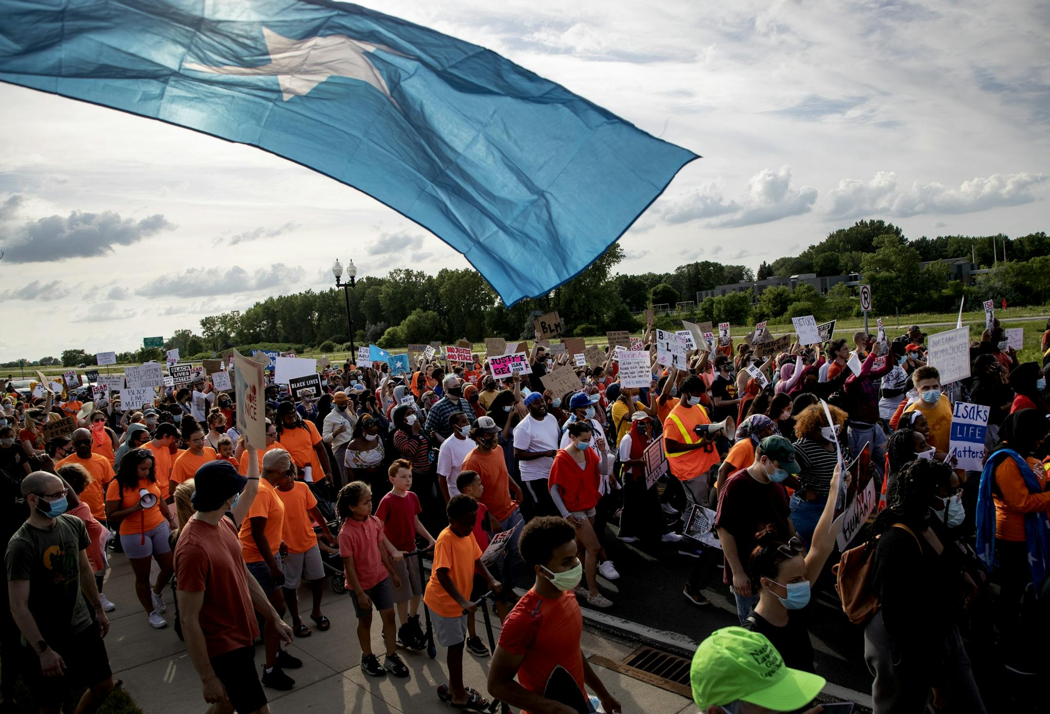 Protesters at rally & march to honor Isak Aden and Somali Independence Day that began near Twin Cities Premium Outlets in Eagan.