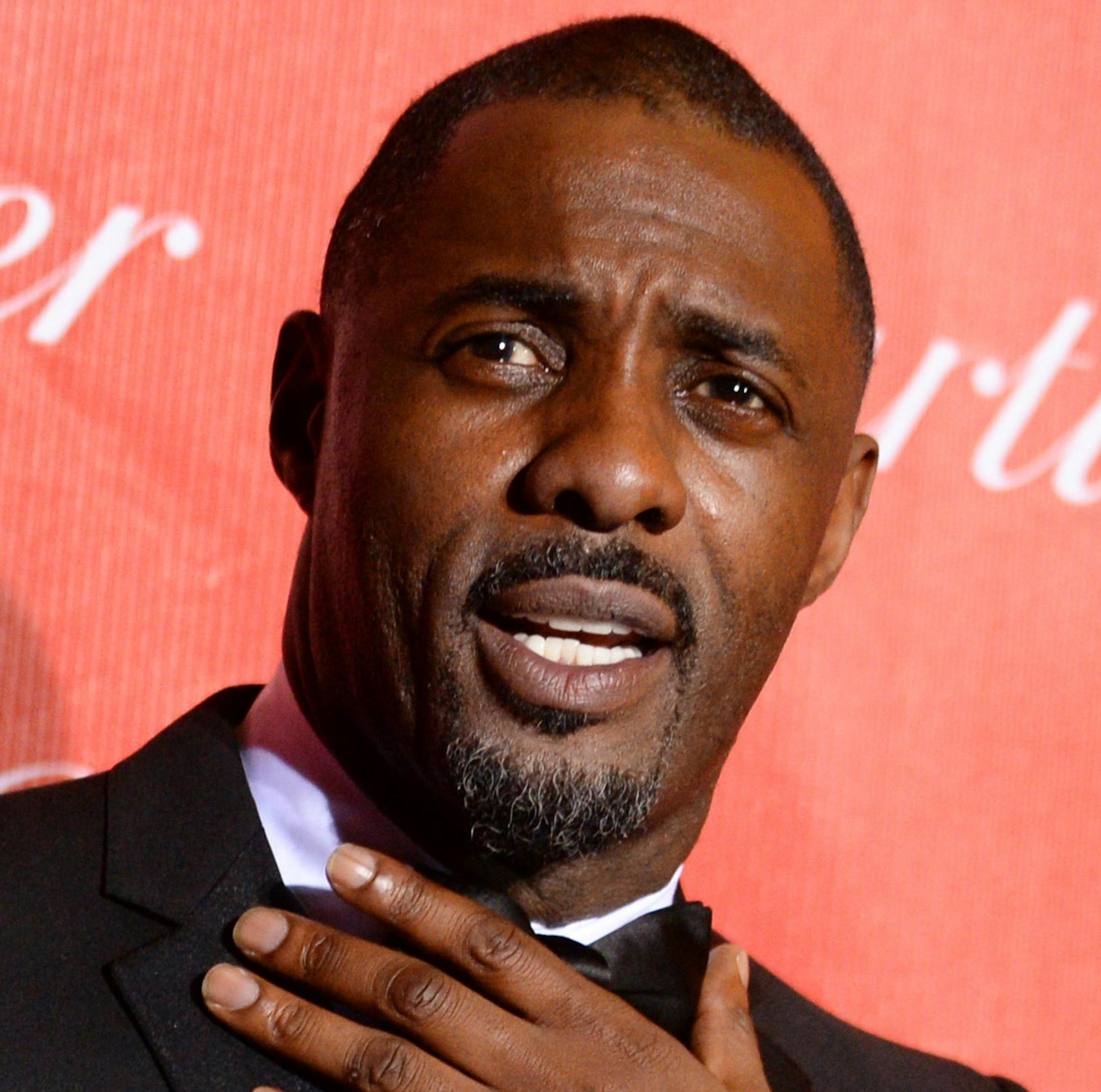 FILE- In this Jan. 4, 2014 file photo, Idris Elba arrives at the Palm Springs International Film Festival Awards Gala in Palm Springs, Calif. Whether actor Daniel Craig will bow out after the James Bond film ìSpectreî or commit to another, his reign is nearly finished and everyoneís wondering just who will step into those bespoke suits. As far as popular, fan-driven casting theories go, the one that suggests Elba for the next Bond seemed harmless. But Bond author Anthony Horowitz&