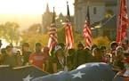 Supporters of President Donald Trump unfurl a giant American flag outside the Pennsylvania State Capitol, Saturday, Nov. 7, 2020, in Harrisburg, Pa., 