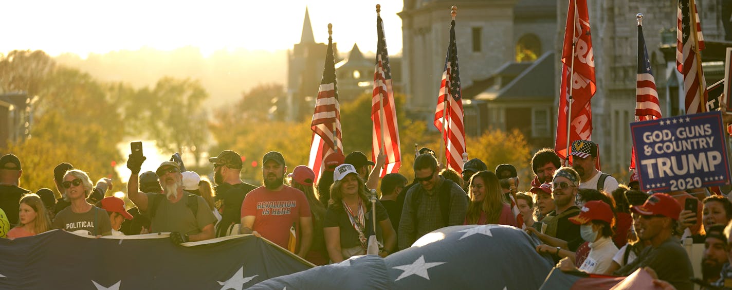 Supporters of President Donald Trump unfurl a giant American flag outside the Pennsylvania State Capitol, Saturday, Nov. 7, 2020, in Harrisburg, Pa., after Democrat Joe Biden defeated Trump to become 46th president of the United States. (AP Photo/Julio Cortez)