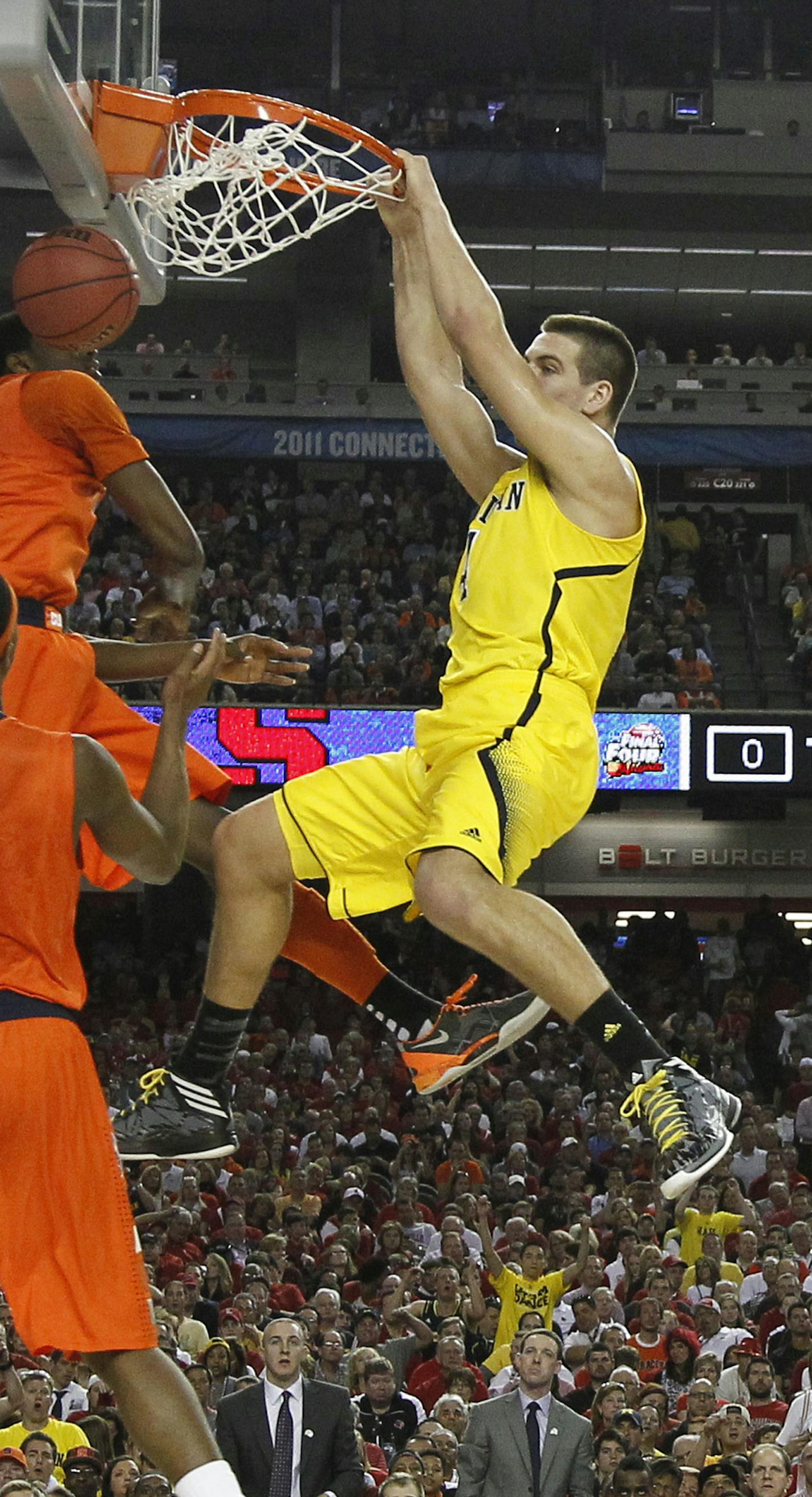 Mitch McGary of the Michigan Wolverines dunks in first-half action against Syracuse in an NCAA Final Four semifinal at the Georgia Dome in Atlanta, Georgia, Saturday, April 6, 2013. Michigan advanced to the final, 61-56. (Mark Cornelison/Lexington Herald-Leader/MCT) ORG XMIT: 1137192