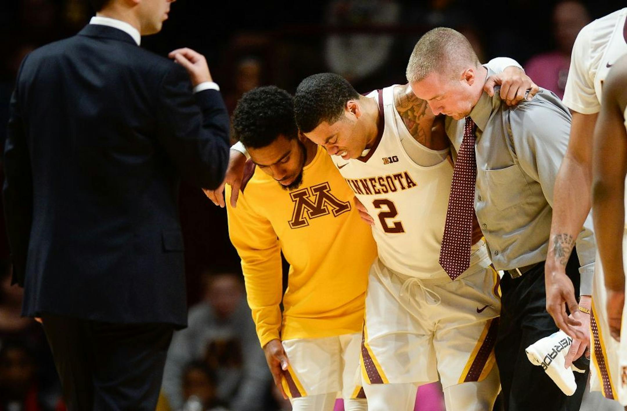 Minnesota Golden Gophers guard Nate Mason (2) winced in pain as he was helped off the floor after suffering a leg injury in the second half against the Florida Atlantic Owls.