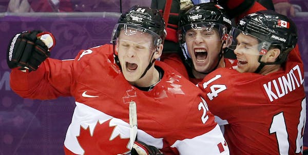 Canadians, including Corey Perry, left, and Chris Kunitz, celebrated at game&#x2019;s end. Canada plays Sweden for the gold medal Sunday.