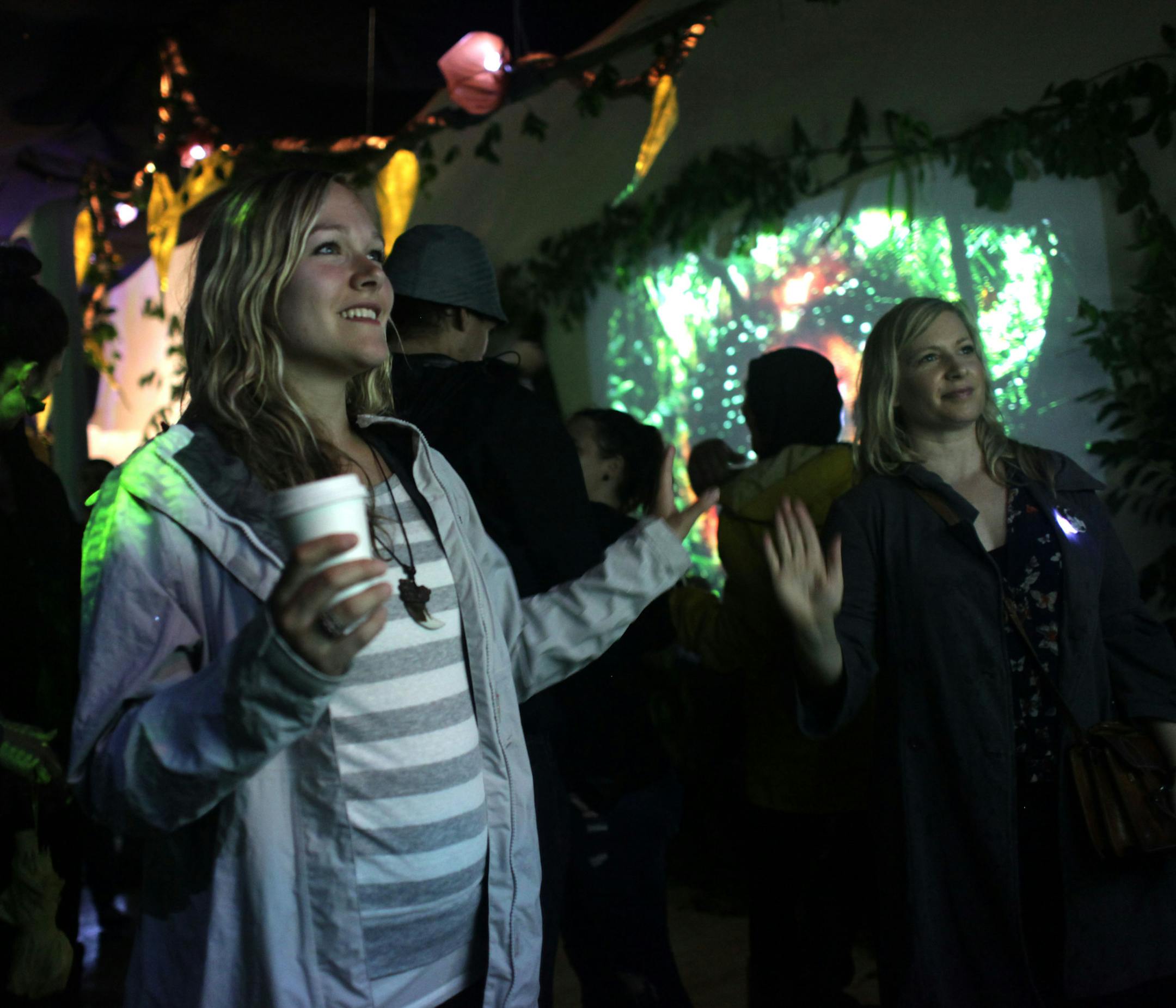 Andi Rain and Tracy Philippi interact with a projection at the Intergalactic Garden at Gamut Gallery during Northern Spark on Saturday night. ] MONICA HERNDON monica.herndon@startribune.com Minneapolis, MN 06/14/2014 Andi