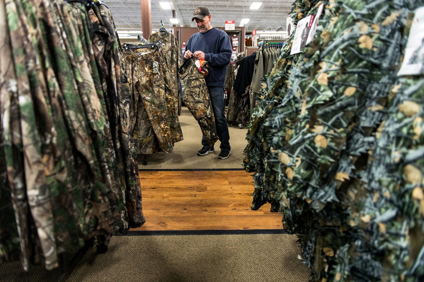 Alex Kilpatrick shopped for new camouflage pants and a hat at Gander Mountain in Blaine Friday. He is going hunting up near Cambridge with his son this weekend. ] (AARON LAVINSKY/STAR TRIBUNE) aaron.lavinsky@startribune.com Deer hunters did some last minute shopping for the firearm season opener at Gander Mountain on Friday, Nov. 4, 2016 in Blaine, Minn. ORG XMIT: MIN1611041603541064 ORG XMIT: MIN1912191432439731