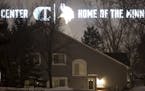 The lights from the signage on the side of the new Vikings practice facility in Eagan illuminate the homes on Lockwood Drive in Mendota Heights.