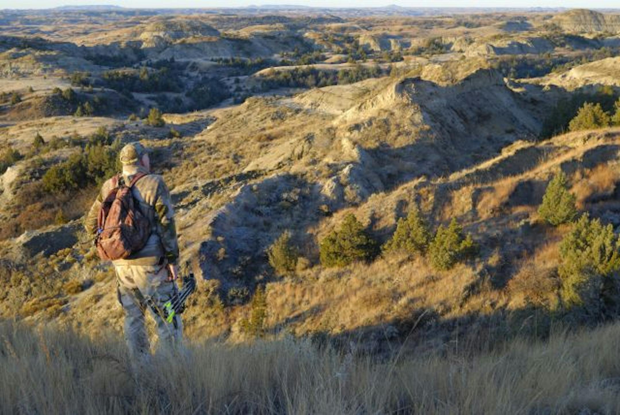 Leo Marchel of Grand Forks, NoDak watches for mule deer during a recent bow hunt in the Badlands.