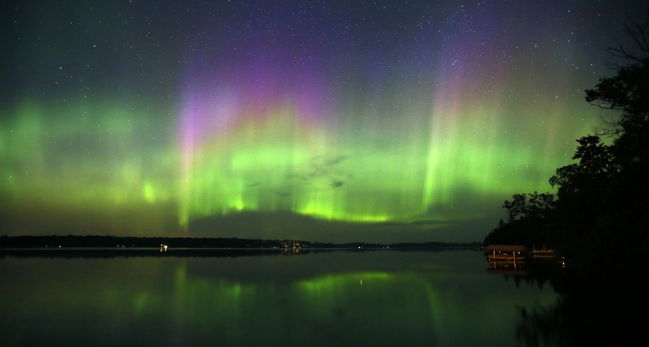 Northern Lights illuminate the sky over Lake Elora in northern Minnesota early Sunday morning, July 15, 2012. (AP Photo/The Star Tribune, Brian Peterson)