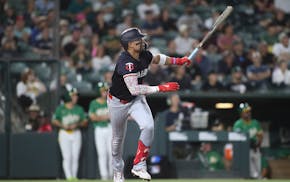 The Twins' Royce Lewis hits a double that drives in two runs against the Athletics during the seventh inning Tuesday night in West Sacramento, Calif.