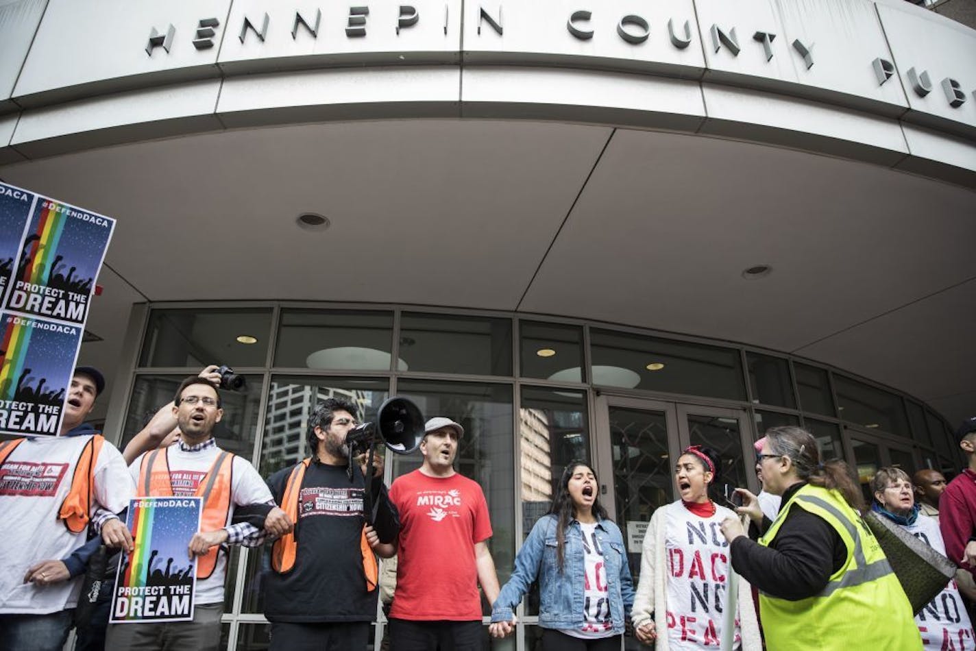 People stood arm in arm in front of the Hennepin County jail Tuesday after marching through Minneapolis in protest after President Donald Trump announced his plans to rescind DACA.