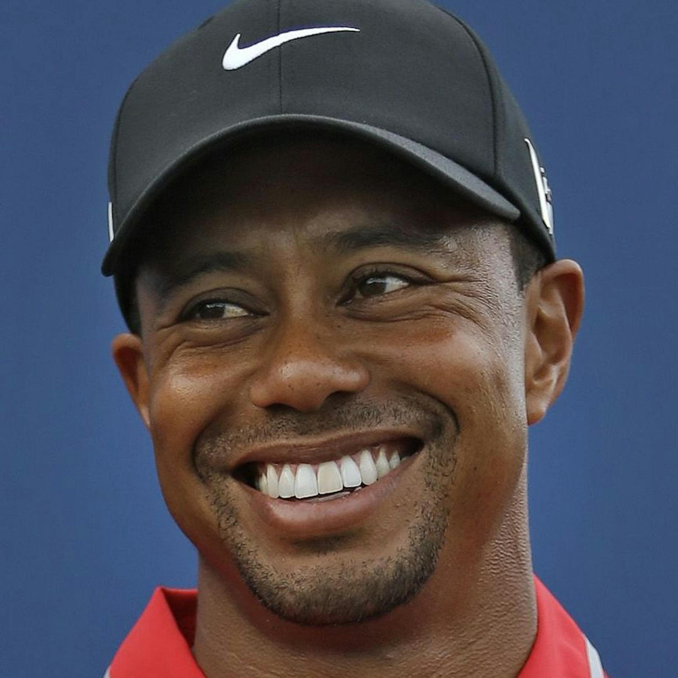 Tiger Woods smiles as he holds the trophy after winning The Players Championship golf tournament at TPC Sawgrass, Sunday, May 12, 2013, in Ponte Vedra Beach, Fla. (AP Photo/John Raoux) ORG XMIT: MIN2013052217395199
