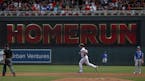 Minnesota Twins Jake Cave runs the bases on a grand slam past Kansas City Royals second baseman Whit Merrifield (15) in the second inning of a basebal