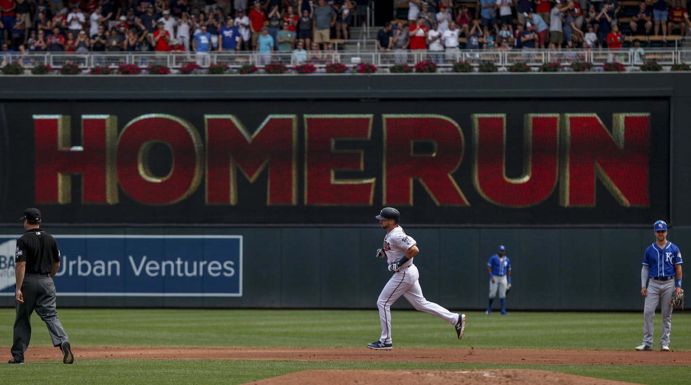 Minnesota Twins Jake Cave runs the bases on a grand slam past Kansas City Royals second baseman Whit Merrifield (15) in the second inning of a baseball game Sunday, Aug. 5, 2018, in Minneapolis. (AP Photo/Bruce Kluckhohn)