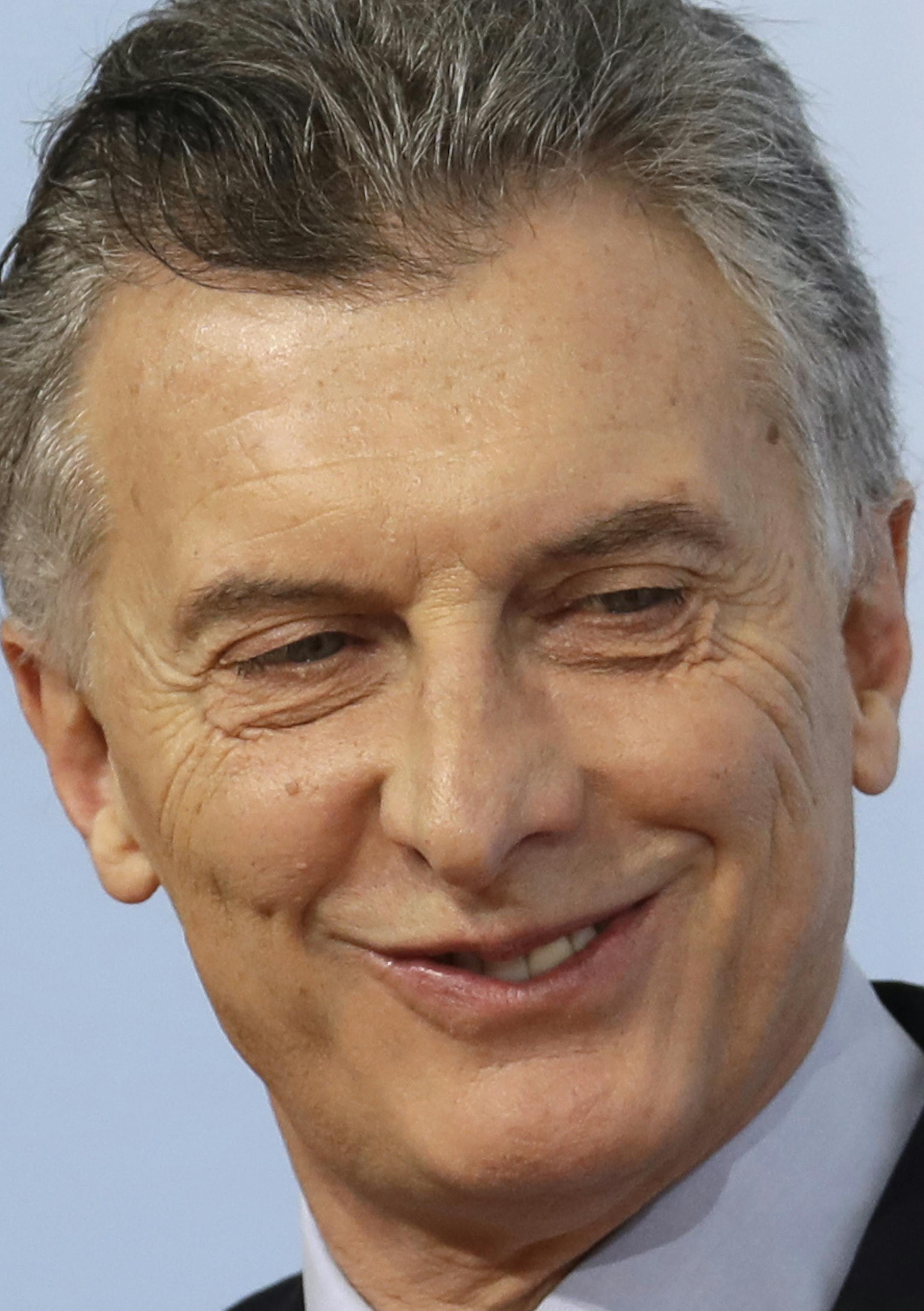 Argentinian President Mauricio Macri, left, is welcomed by German Chancellor Angela Merkel on the first day of the G-20 summit in Hamburg, northern Germany, Friday, July 7, 2017. The leaders of the group of 20 meet July 7 and 8. (AP Photo/Michael Sohn)