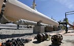 In this June 8, 2017, file photo, fresh nuts, bolts and fittings are ready to be added to the east leg of the pipeline near St. Ignace, Mich., as Enbr