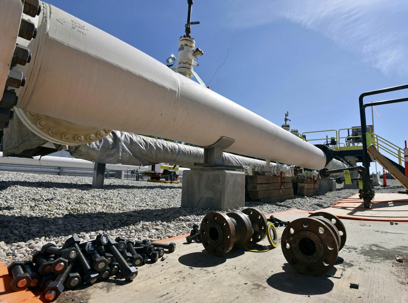 In this June 8, 2017, file photo, fresh nuts, bolts and fittings are ready to be added to the east leg of the pipeline near St. Ignace, Mich., as Enbridge Inc., prepares to test the east and west sides of the Line 5 pipeline under the Straits of Mackinac in Mackinaw City, Mich. (Dale G Young/Detroit News via AP, File) ORG XMIT: MERc8302668d4f9d8632c2e2ea4e16e0