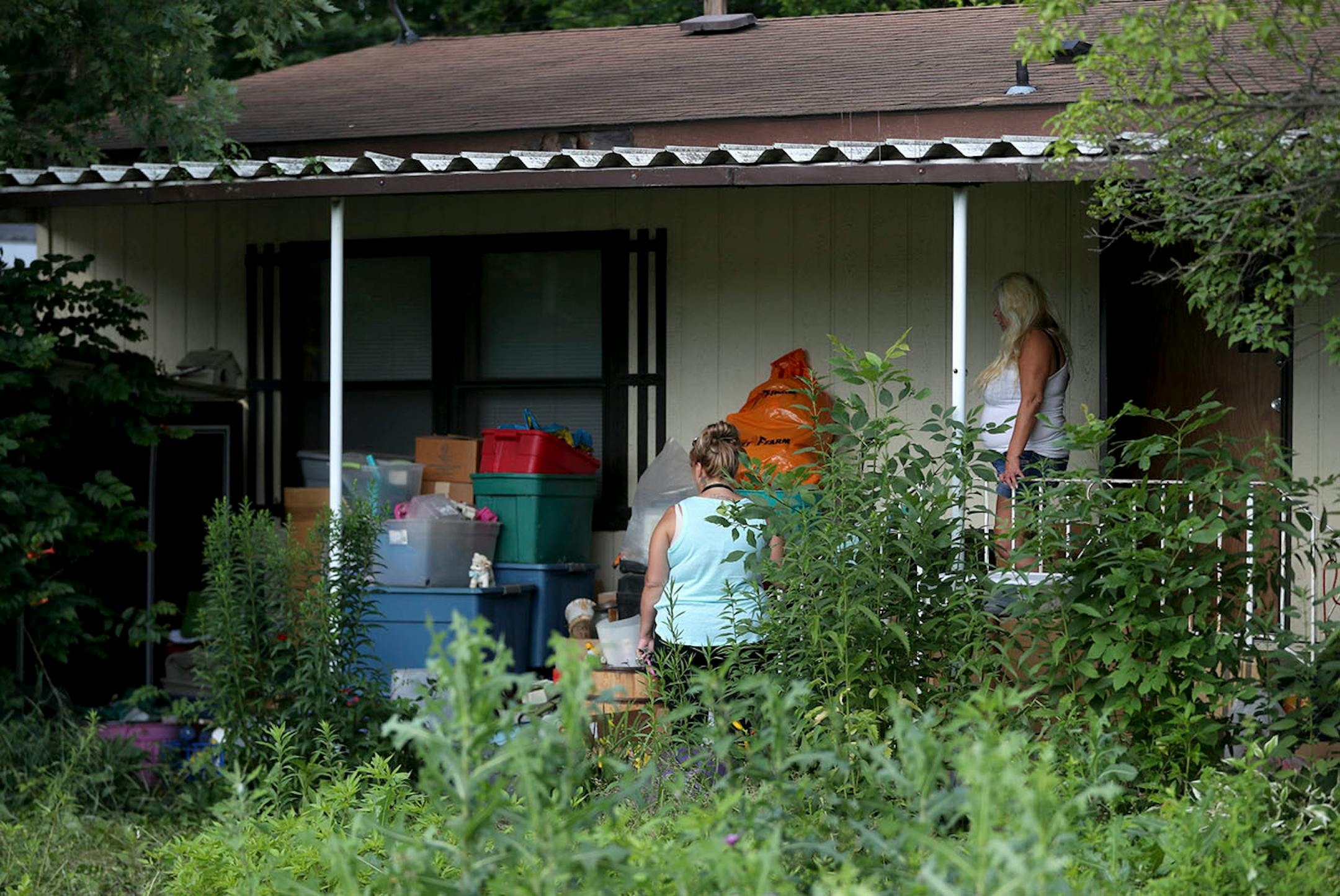 A Lowry Grove mobile home resident looks over her belongings during the final hours of the manufactured home park's existence Friday, June 30, 2017, in St. Anthony, MN. Lowry Grove closed it's gate and all residents had to be gone by 12 midnight the following day, the space slated to be redeveloped into multiple-family housing. Some residents didn't know where they would go and talked of being homeless and sleeping in a vehicle.
