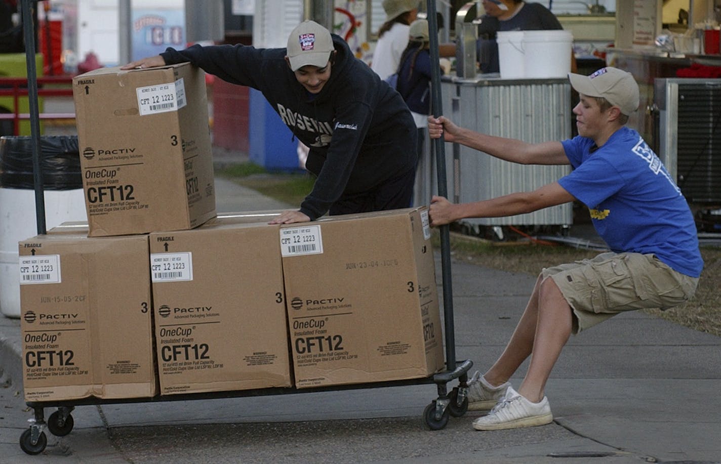 JOEY MCLEISTER &#xef; jmcleister@startribune.com Falcon Heights,Mn.,Tues.,Aug. 30, 2006--(Left to right) Nick Gawreluk (cq.) and Carl Drache, both 15 years old and both from St. Paul, make an early morning delivery of cups to the All You Can Drink Milk booth where they work at the State Fair. (Gawreluk was riding on the cart, so Drache had to pull hard.)
GENERAL INFORMATION: Early morning at the Minnesota State Fair.