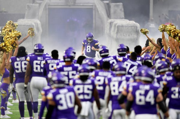 Vikings quarterback Kirk Cousins runs onto the field at the start of the game against the Lions on Dec. 8, 2019.