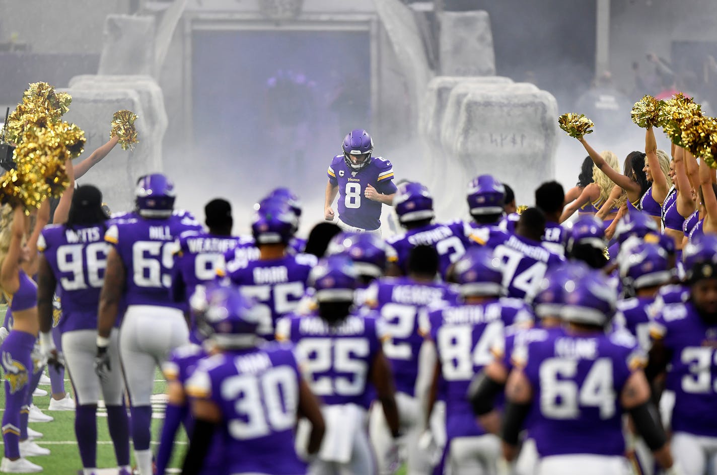 Vikings quarterback Kirk Cousins runs onto the field at the start of the game against the Lions on Dec. 8, 2019.