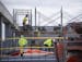 Construction workers stood on scaffolding as they worked on building the Vue at BlueStone apartments April 1.
ALEX KORMANN &#x2022; alex.kormann@start