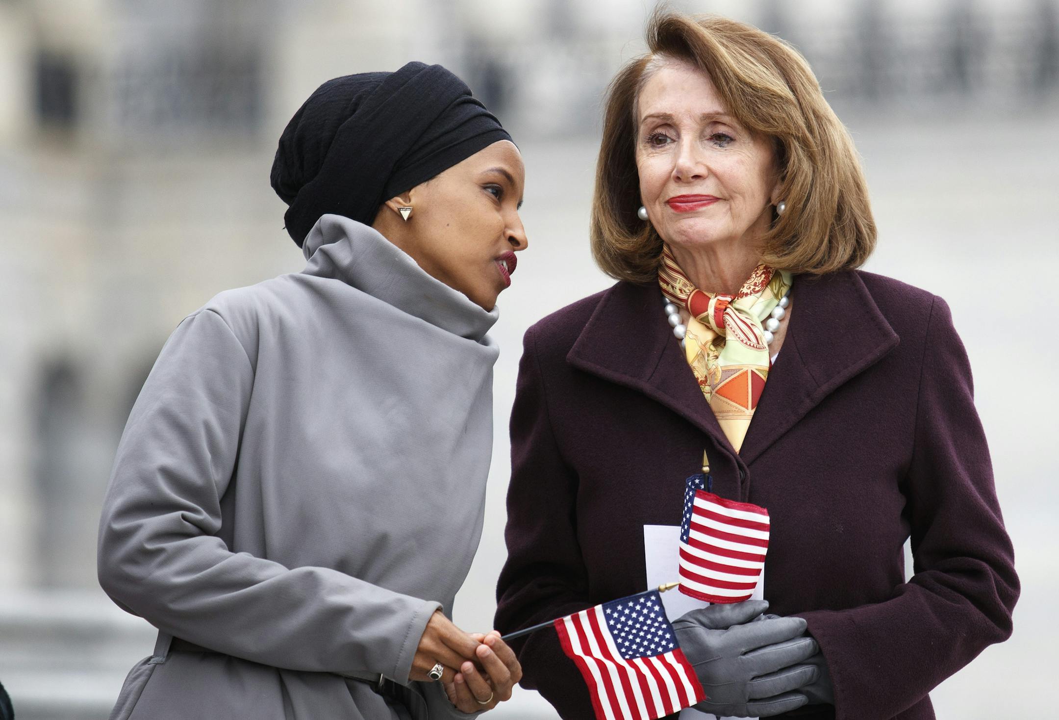 Rep. Ilhan Omar (D-Minn.), left, talks with House Speaker Nancy Pelosi (D-Calif.) during a news conference outside the U.S. Capitol in Washington, March 8, 2019.