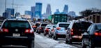 Traffic crawled into downtown Minneapolis from the south along I-35W as an early snow was compressed into a slippery mess.
